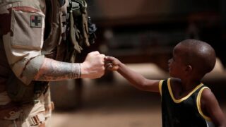 seorang tentara perancis menyapa seorang anak saat tentara melakukan patroli CIMIC (Civil-Military Co-operation) selama Operas Barkel regional anti-pemberontakan di Gao, Mali. (Tempo)